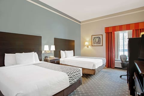 Premium bedding, desk, laptop workspace, blackout drapes