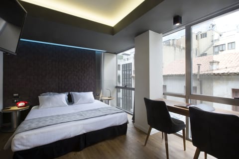 Deluxe Double Room | Living area | 28-inch flat-screen TV with satellite channels, TV