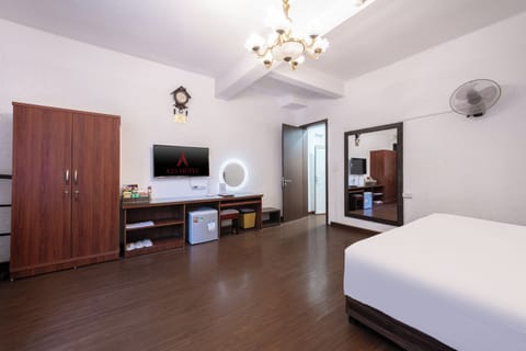 Deluxe Family Room | Minibar, in-room safe, blackout drapes, iron/ironing board