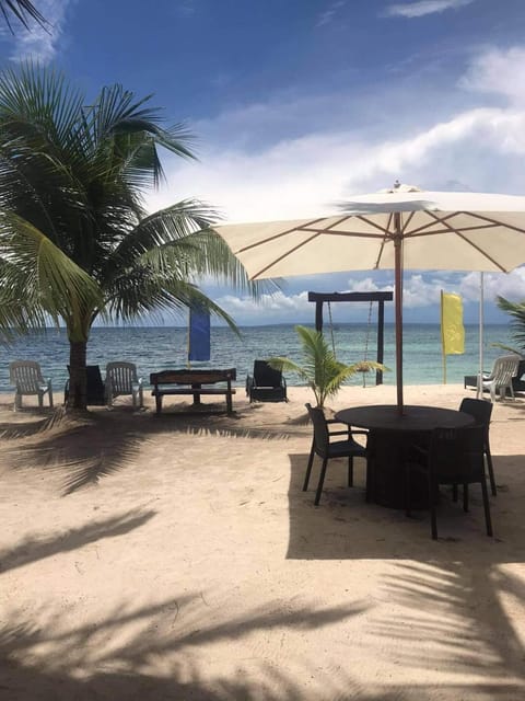 On the beach, white sand, sun loungers, beach umbrellas
