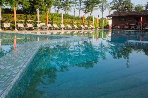 Seasonal outdoor pool, open 9:30 AM to 7:00 PM, pool umbrellas
