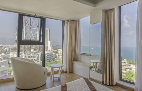 Senior Deluxe, Sea View | Living area | 40-inch flat-screen TV with cable channels, TV