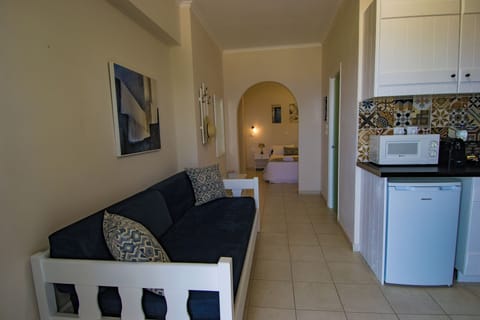 Apartment, Sea View | Living area | Flat-screen TV