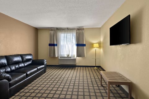 Suite, 1 King Bed, Non Smoking | Desk, laptop workspace, blackout drapes, iron/ironing board