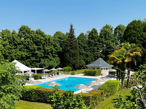 Seasonal outdoor pool, open 10:00 AM to 7:00 PM, pool umbrellas
