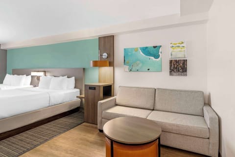 Premium bedding, desk, laptop workspace, blackout drapes