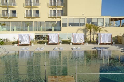 Outdoor pool, open 9:00 AM to 6:00 PM, pool umbrellas, sun loungers