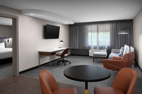 Premium bedding, desk, laptop workspace, blackout drapes