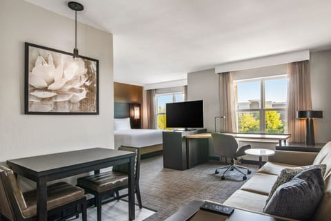 Premium bedding, desk, laptop workspace, blackout drapes