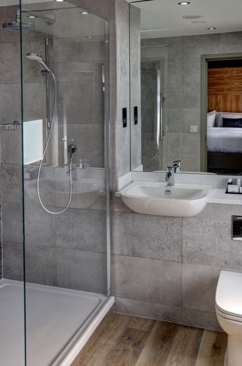 Bathtub, hair dryer, bathrobes, towels