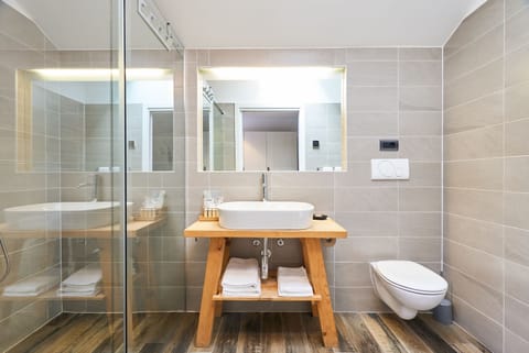 Junior Suite, Lake View | Bathroom | Shower, rainfall showerhead, designer toiletries, hair dryer