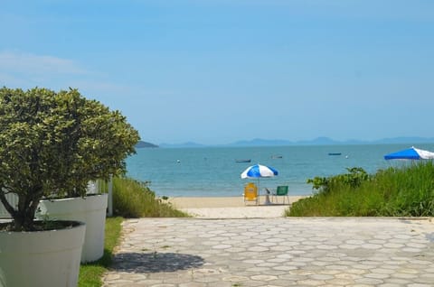 On the beach, white sand, sun loungers, beach umbrellas