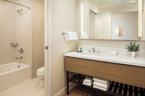 Combined shower/tub, designer toiletries, hair dryer, slippers