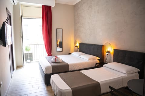 Standard Triple Room | Minibar, in-room safe, desk, blackout drapes