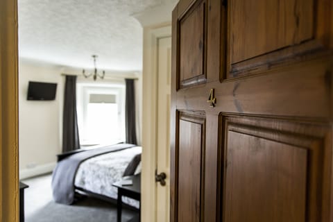 Deluxe Double Room (Room 4) | Premium bedding, desk, laptop workspace, iron/ironing board