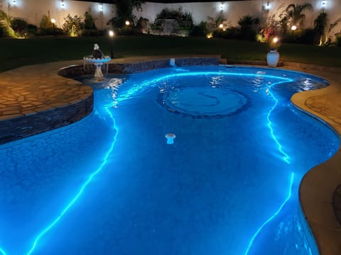 Outdoor pool, open 10:00 AM to 7:00 PM, pool umbrellas