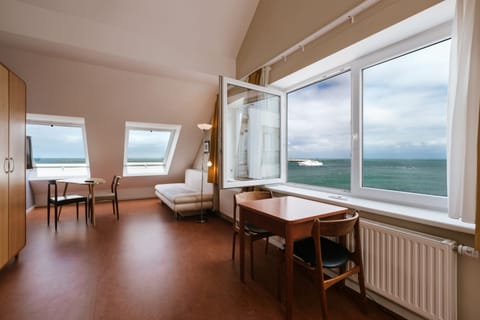 Studio, Sea View | Living area | Flat-screen TV