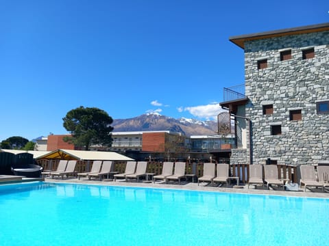 Seasonal outdoor pool, open 8:00 AM to 8:00 PM, pool umbrellas