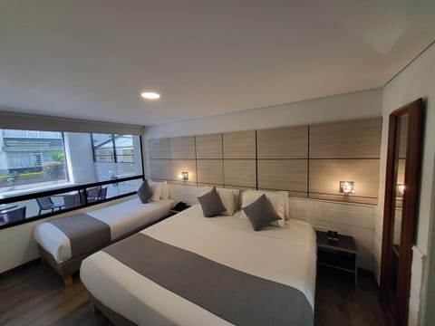 Executive Triple Room | Minibar, in-room safe, desk, iron/ironing board