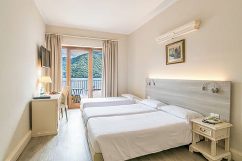 Triple Room, Balcony, Lake View | Down comforters, in-room safe, individually decorated, desk