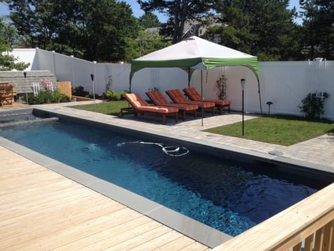 Pool, hot tub, and chaise lounges on shared upper patio area. 