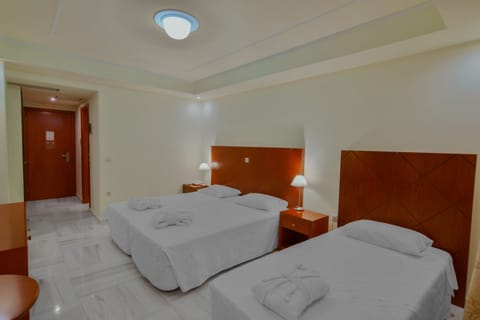 Executive Triple Room, Partial Sea View | Minibar, in-room safe, desk, laptop workspace