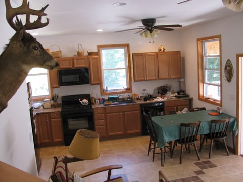kitchen and dining table now w/ 6 chairs, 5 burner stove, microwave, dishwasher