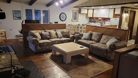 View from flat screen TV: Dramatic living room with grand fireplace home rental