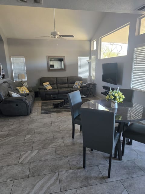 open living area, reclining sofa couches  television, dining table