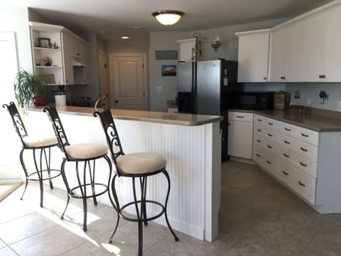 Kitchen bar area is very spacious with very comfortable barstools