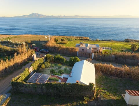 Aerial view of the house with the white roof, Africa in background
