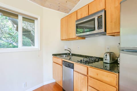 Full-size refrigerator, Italian gas stovetop, convection oven, and dishwasher.