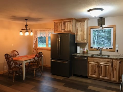 wood plank style flooring, upscale black stainless steel appliances