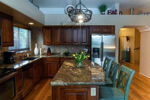 Fully stocked kitchen with stainless appliances and granite counters