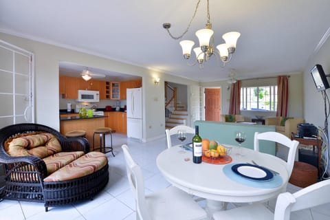 Dining Room Set for 2 in the Foreground with Background View of the Living Room and Front Door 