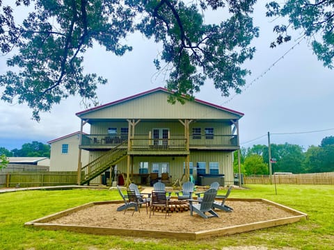 Rear of Barndo has fire pit, gas bbq, hot tub, rockers, and accent lighting.