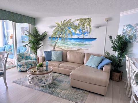 Living area with large screen TV, ocean front view