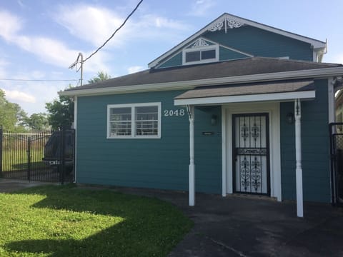 Exterior front with locked gated driveway on side of house 