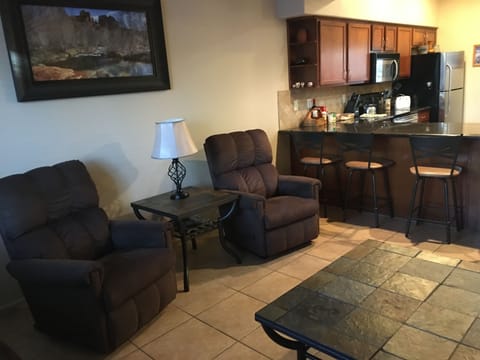 Living Room and  Kitchen separated by Counter w/  4 Stools. Love Seat replaced 