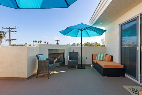 Rooftop deck, cozy fireplace, plenty of seating, and views of the city and bay. 