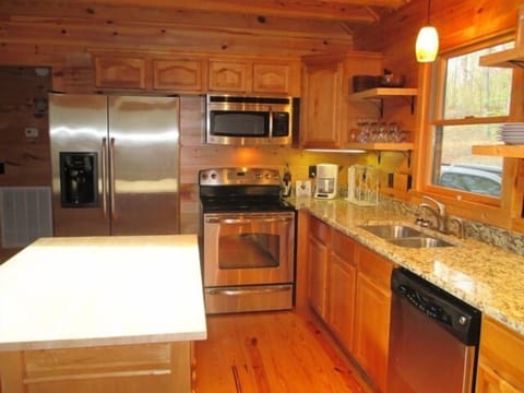 Fully equipped kitchen with granite counter-tops and stainless steel appliances