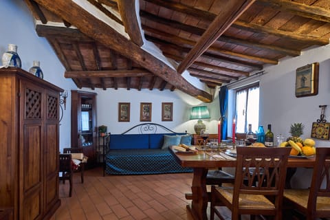 living room with dining area, kitchenette and comfortable sofa bed