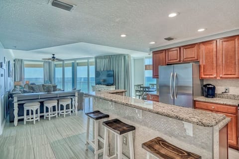 Open kitchen with stainless appliances and granite countertops