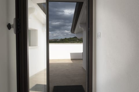 Upper doorway to second large balcony views of mountains and sea