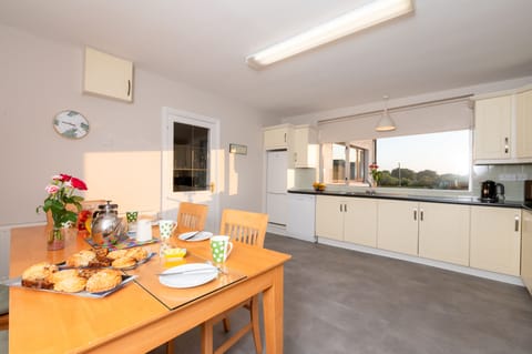Kitchen with LVT flooring. Well stocked - pots/pans, dishes, cutlery, glassware