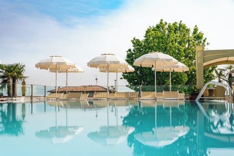 Seasonal outdoor pool, open 9:00 AM to 8:00 PM, pool umbrellas
