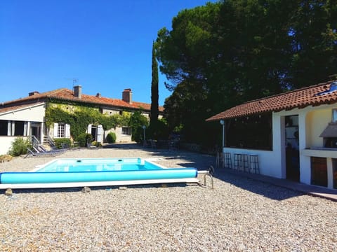 Pool and house with bar and pizza oven in foreground