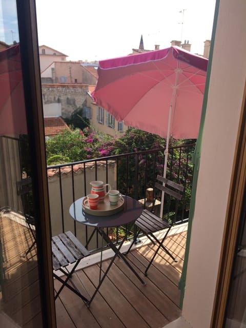 south facing balcony with folding table umbrella and small loungers
