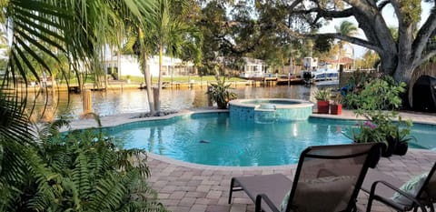 Beautiful free form pool with Jacuzzi over looking wide 120 ft canal