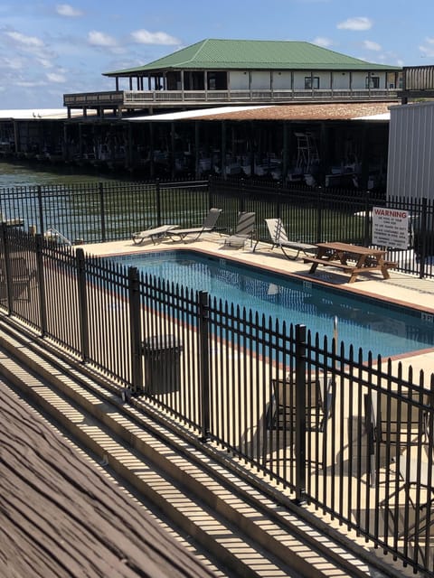 Balcony from living room with pool and water view to boat slots. 